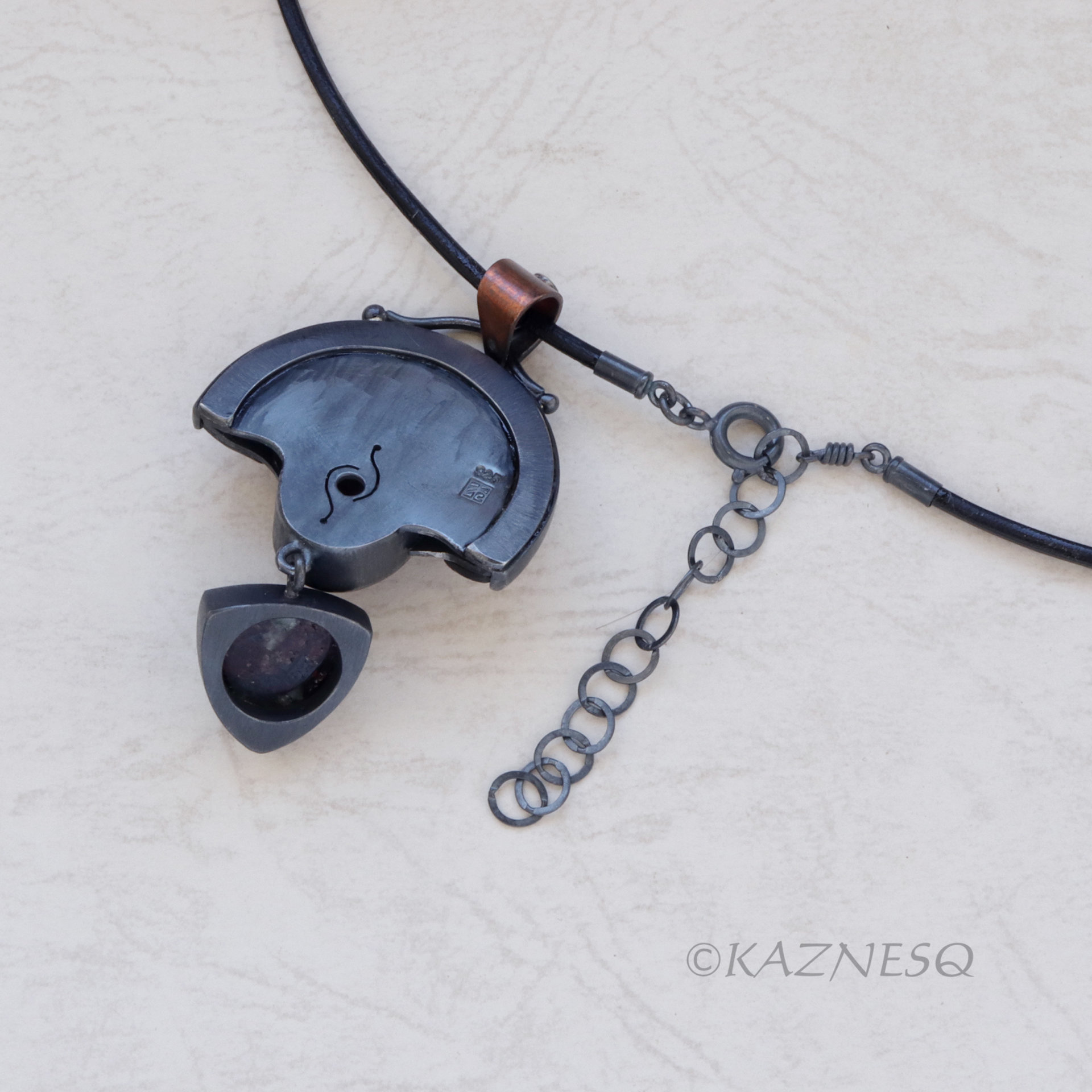 Quartz lined with Black Mother of Pearl Openwork Copper and oxidized silver Arch pendant featuring Eudialyte