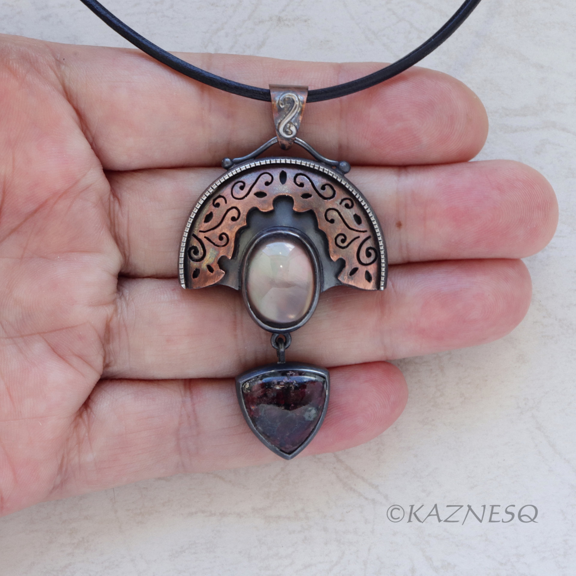 Quartz lined with Black Mother of Pearl Openwork Copper and oxidized silver Arch pendant featuring Eudialyte