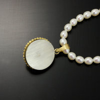 Gold silver round pendant with a pearl necklace