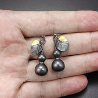 Gourd earrings of patinaed silver with fine gold leaf