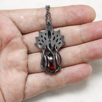 Art Nouveau style tentacles pendant necklace with garnet.