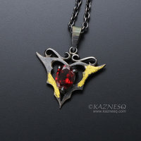 Goth taste silver pendant necklace with oval garnet and gold leaf