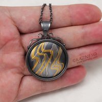 (C) KAZNESQ: Keum Boo oxidized silver round pendant of water pattern and fishes