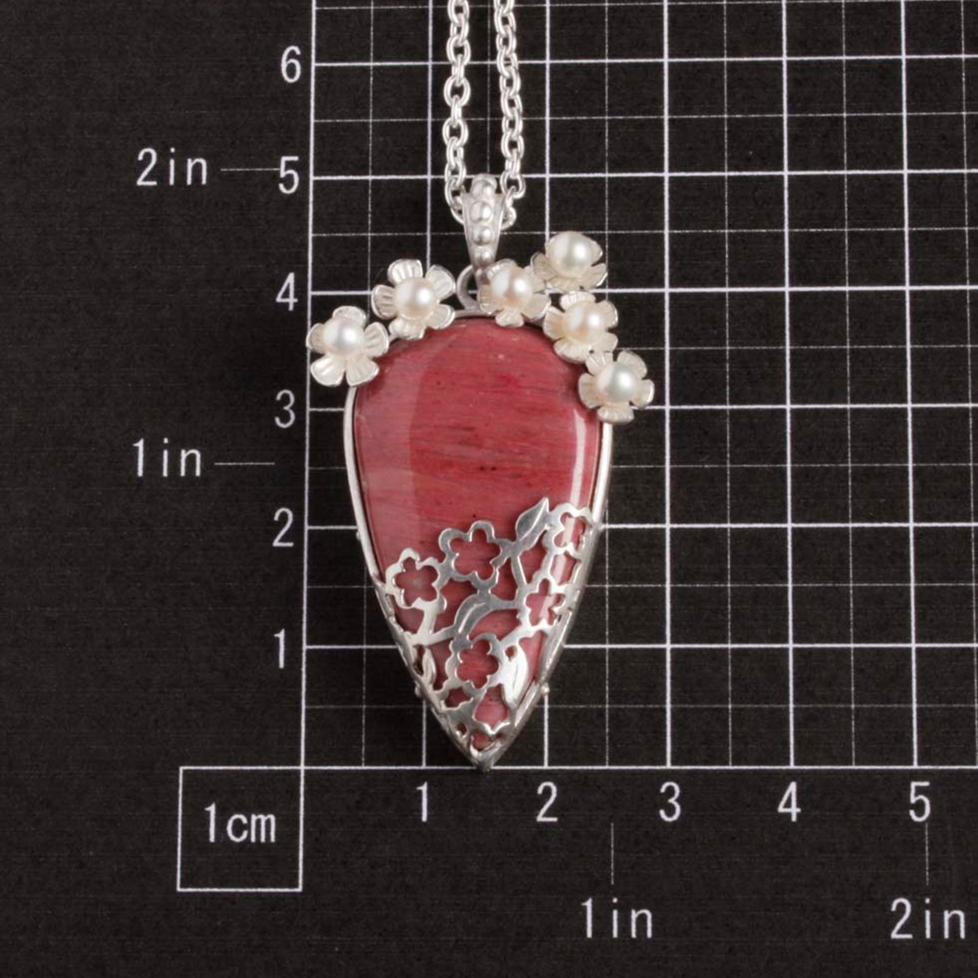 Lacy openwork silver pendant with piemontite.