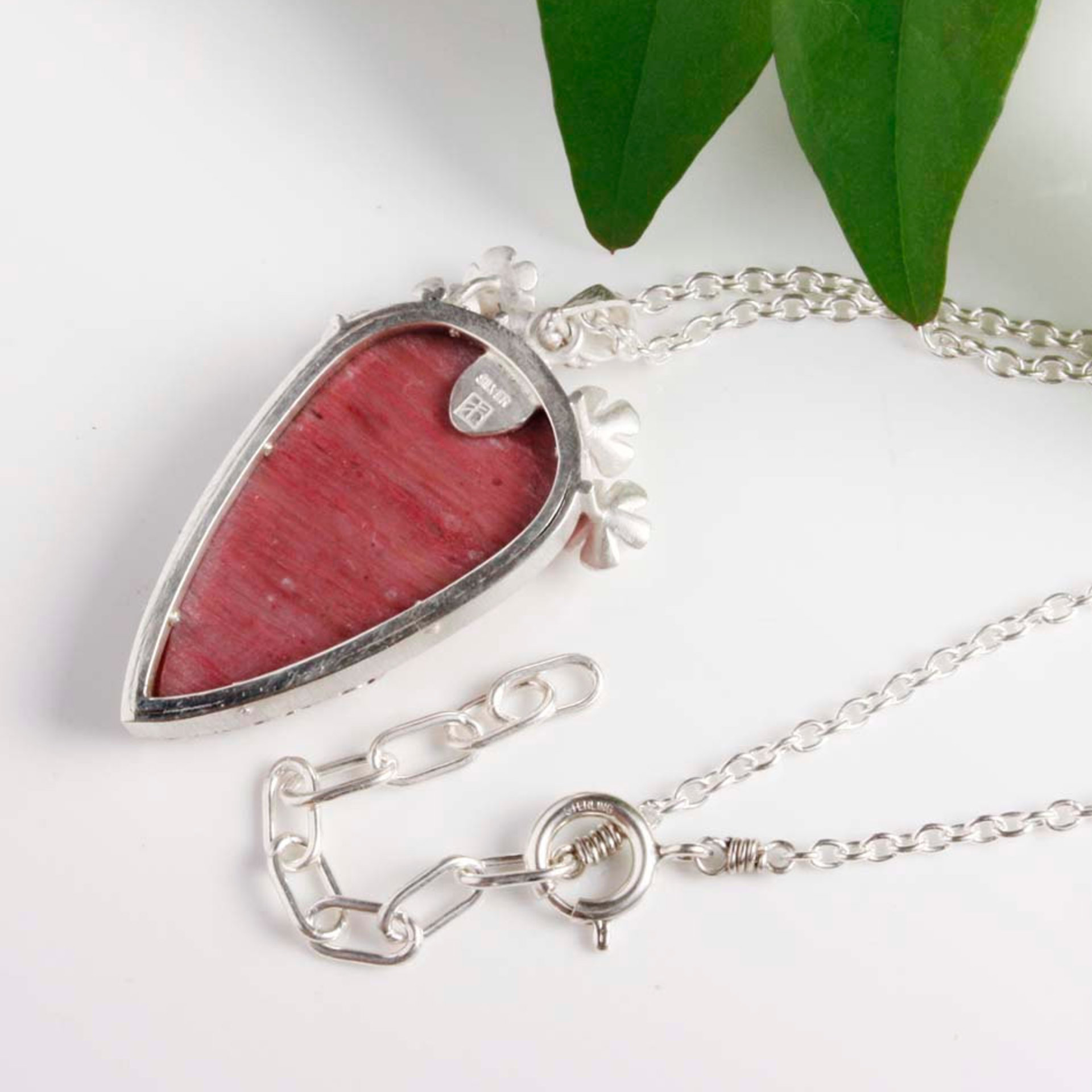 Lacy openwork silver pendant with piemontite.