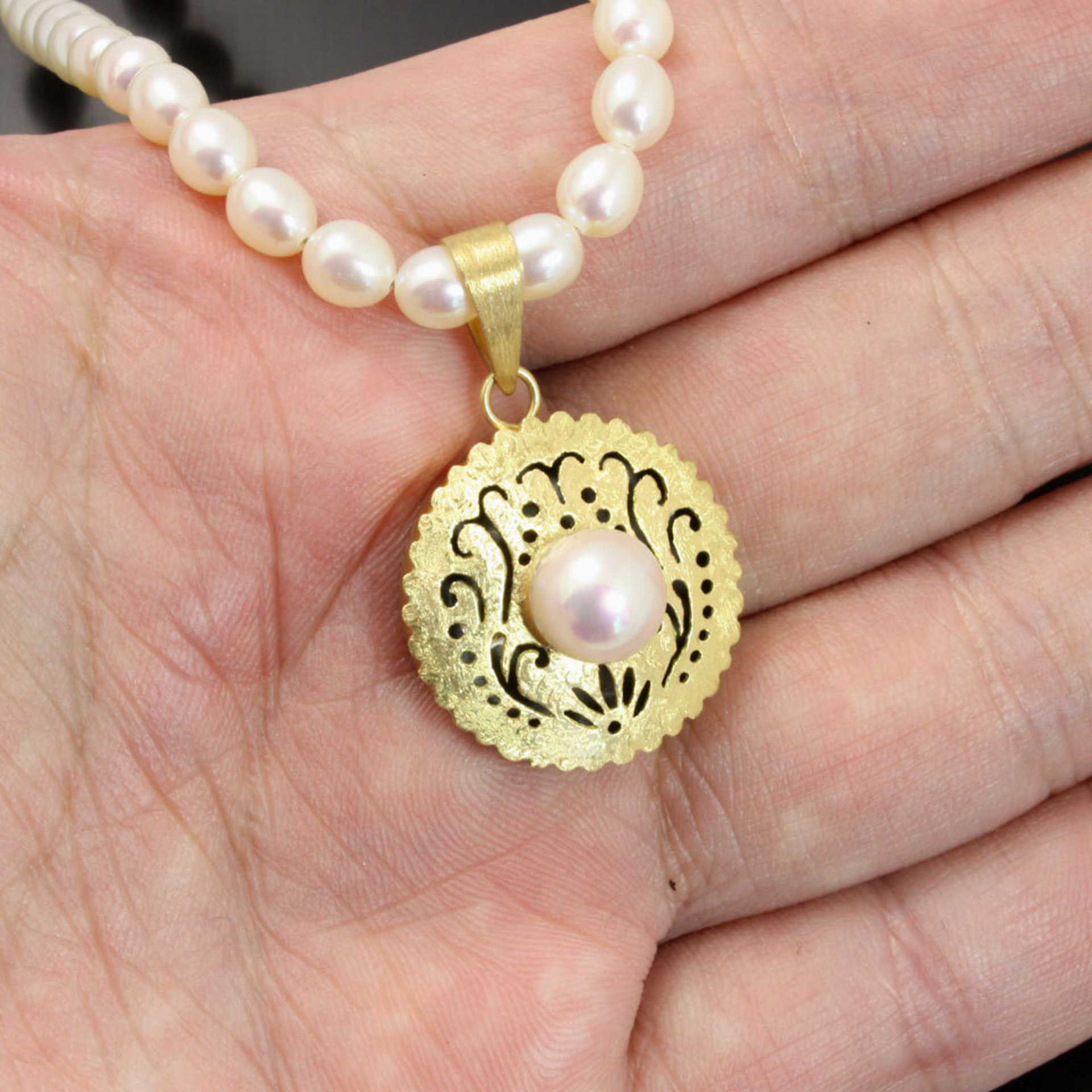 Gold silver round pendant with a pearl necklace