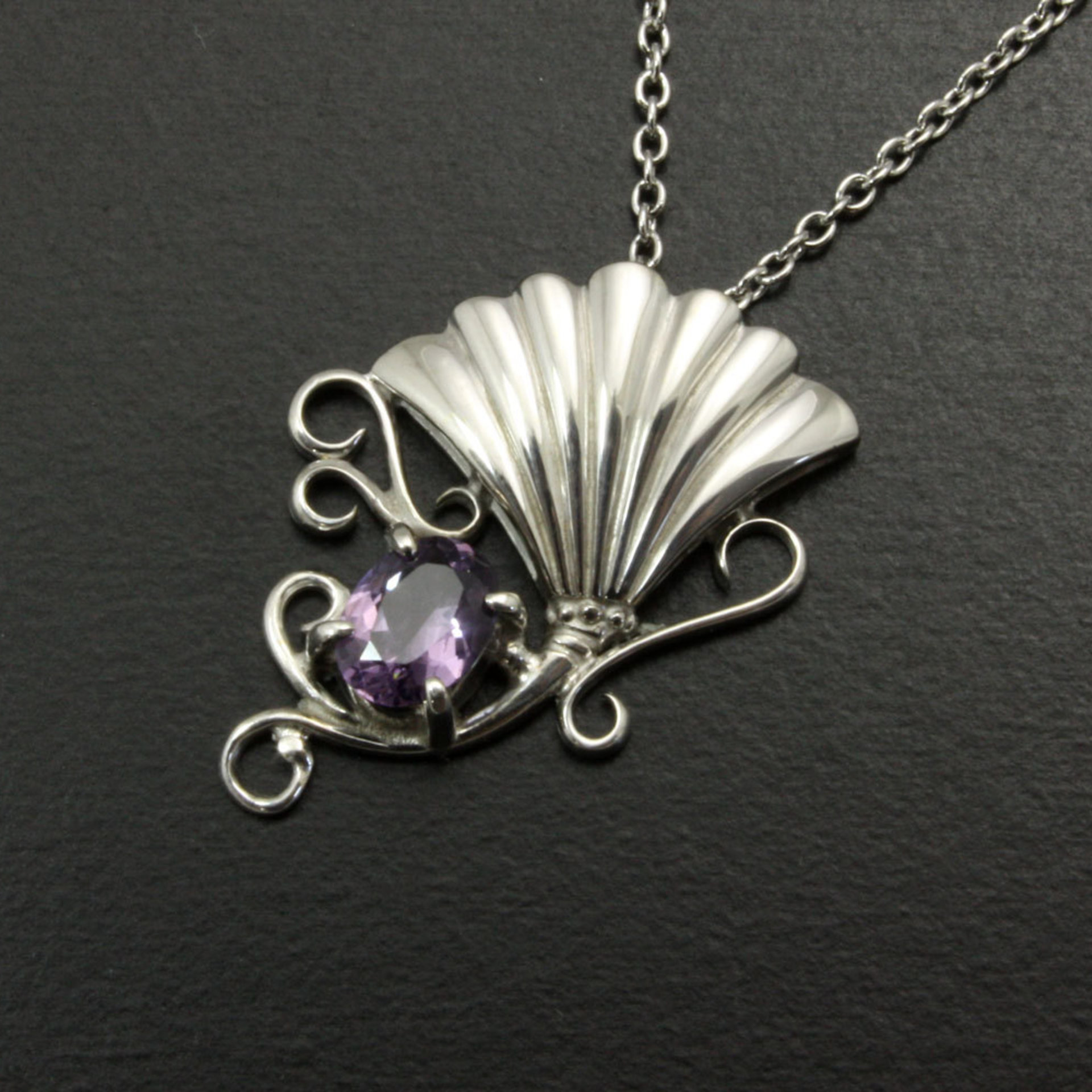Purple spinel featured silver pendant of an imaginary flower