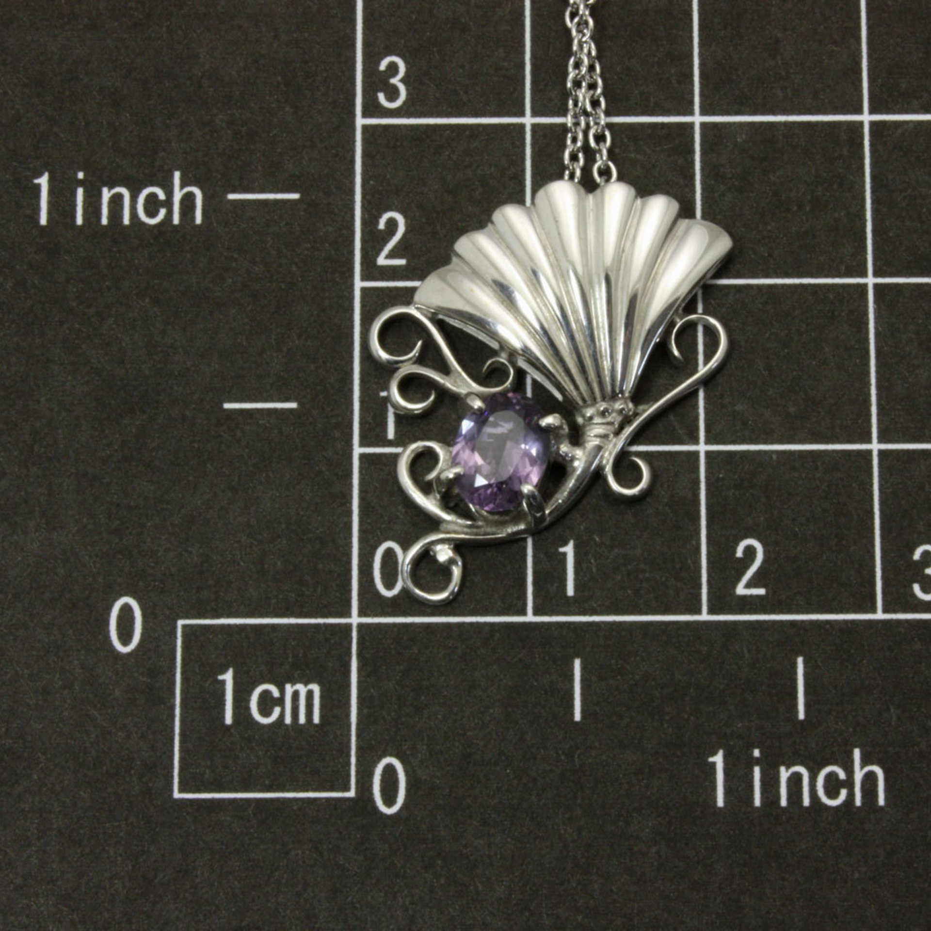 Purple spinel featured silver pendant of an imaginary flower