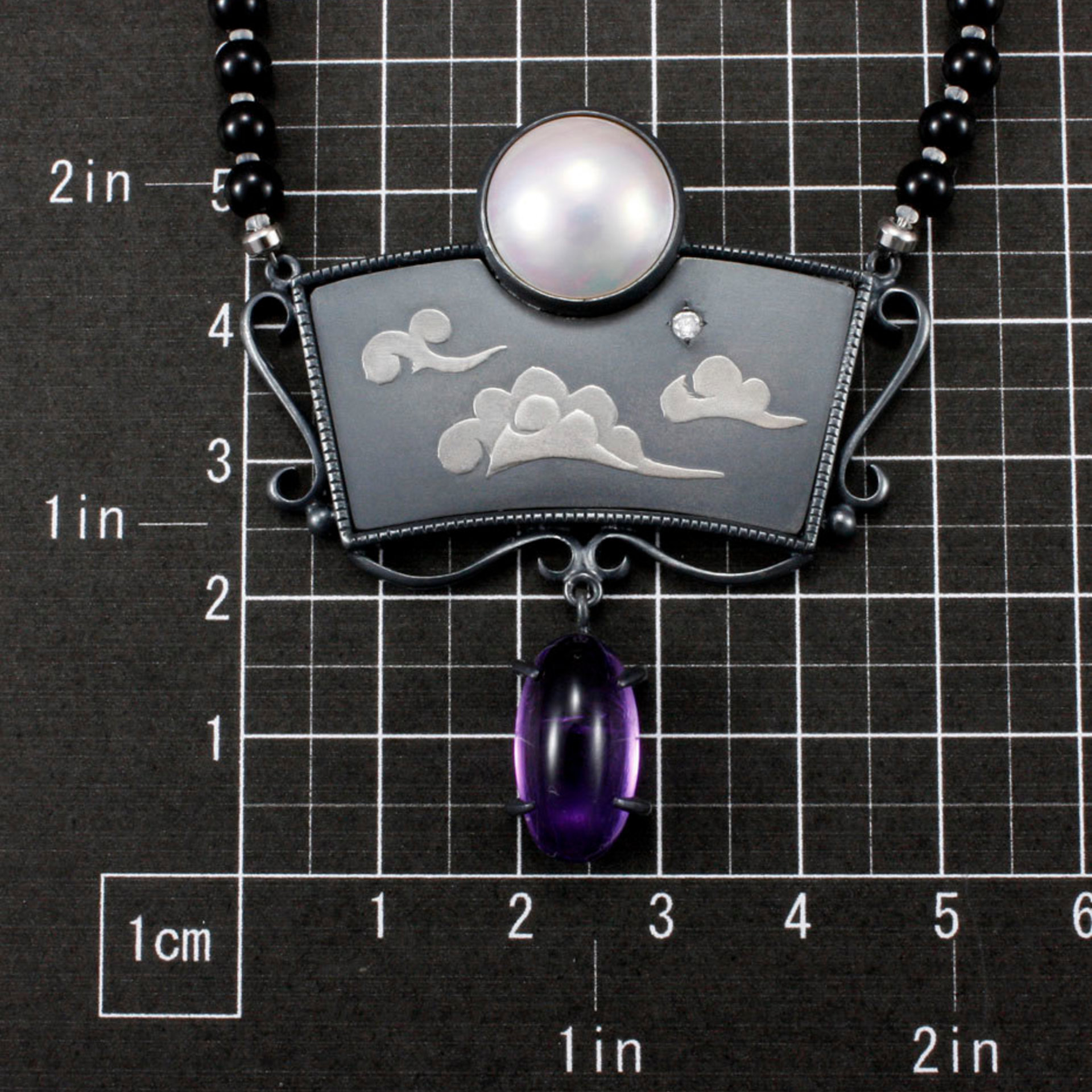 SOLD: The moon and the morning star necklace with a mabe, a diamond, and amethysts.