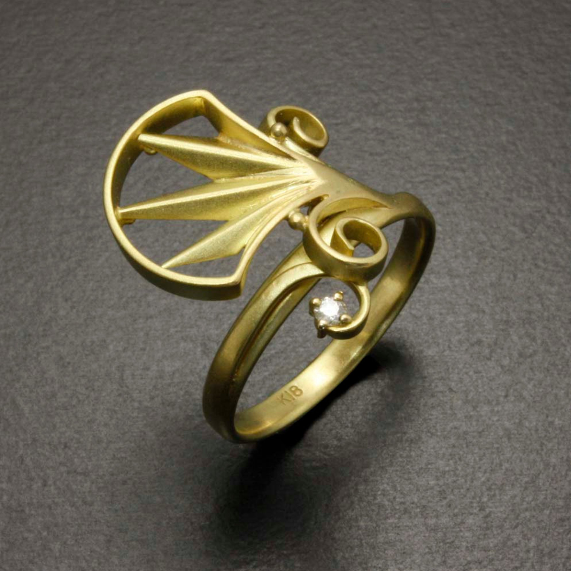 Arch and scroll 18K gold ring with a diamond