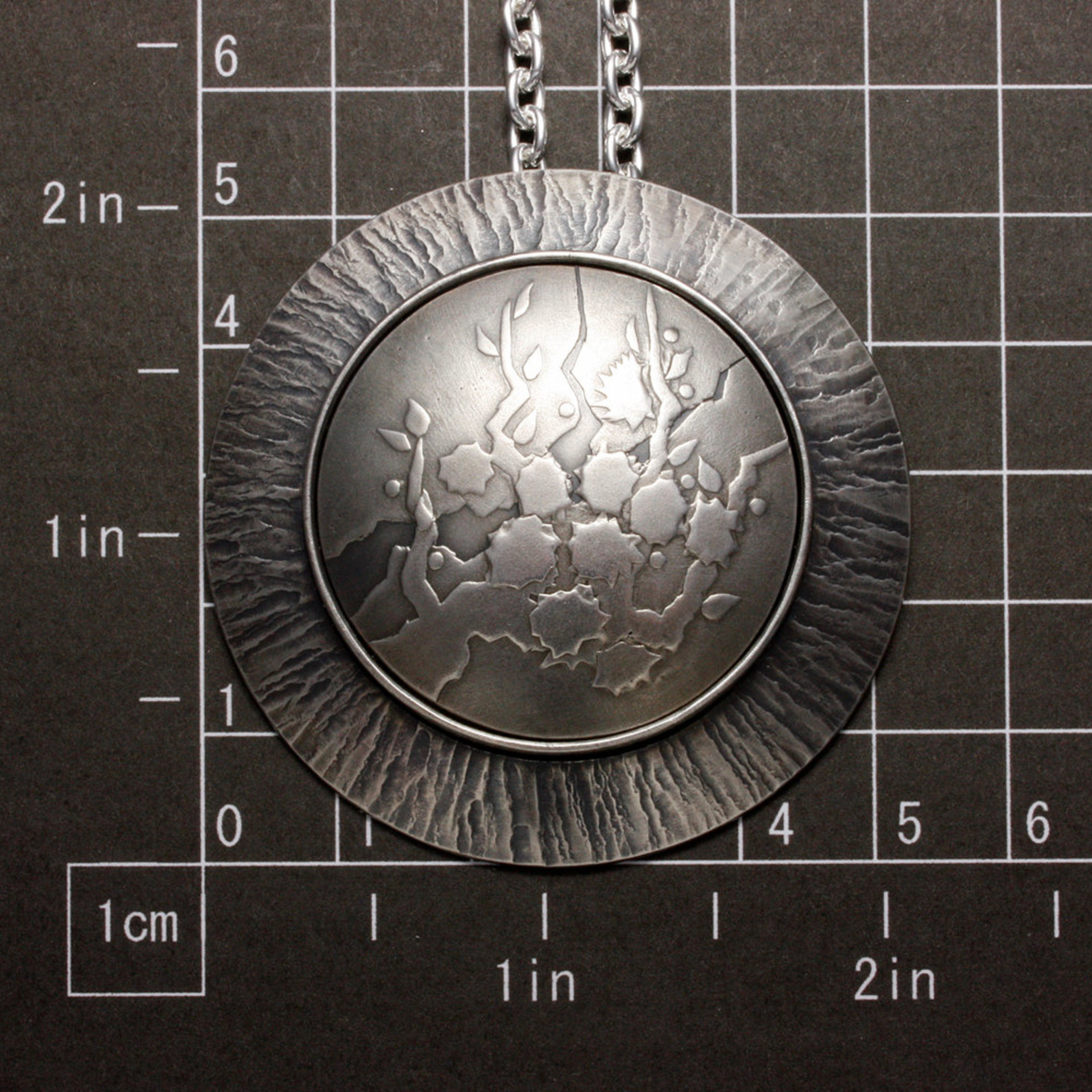 SOLD: Round Keum Boo silver pendant of white blossoms motif