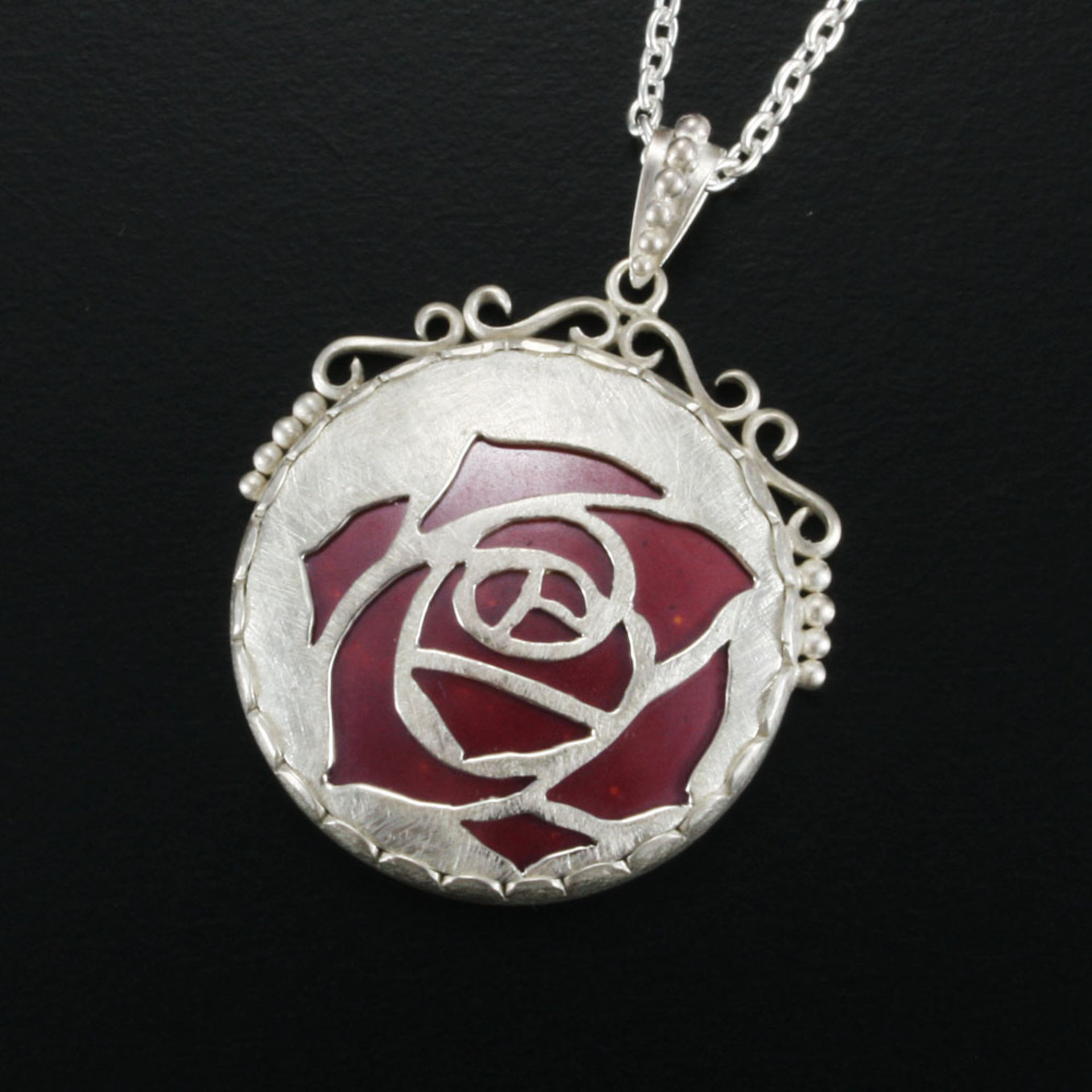 Sold Sale: Burgundy rose open work pendant with heat patinaed copper