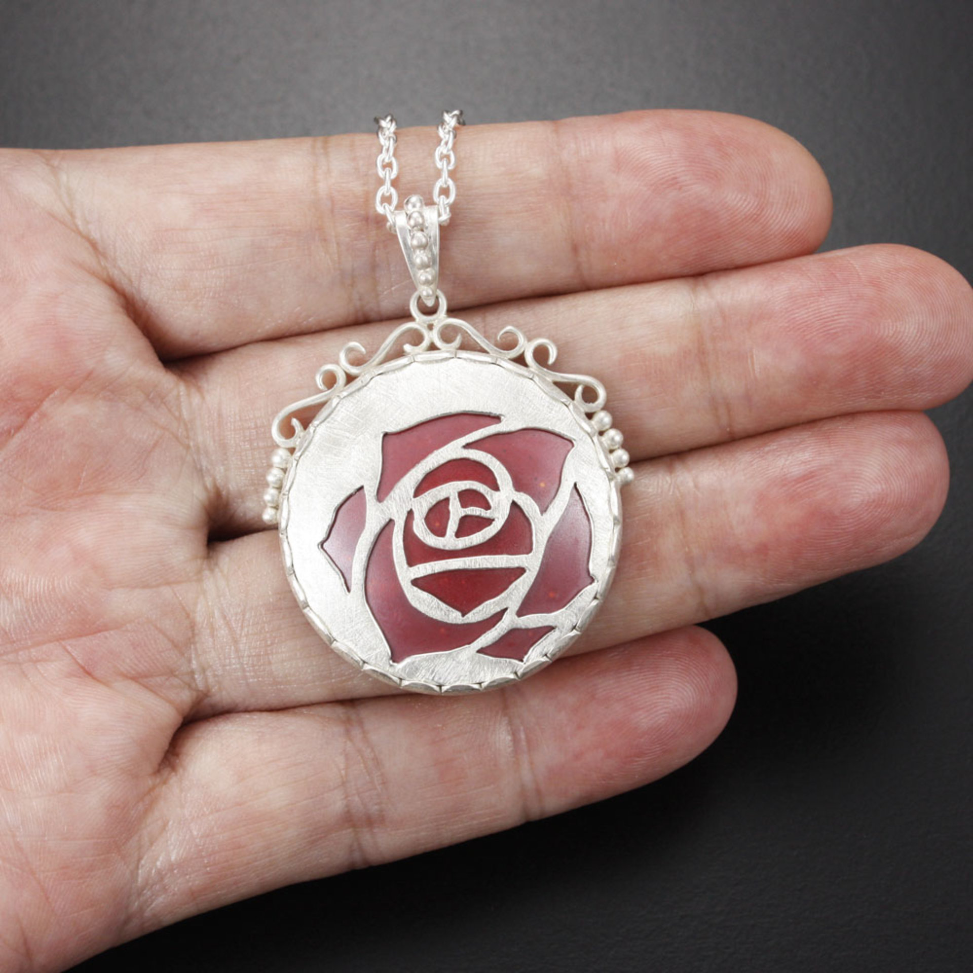 Sold Sale: Burgundy rose open work pendant with heat patinaed copper