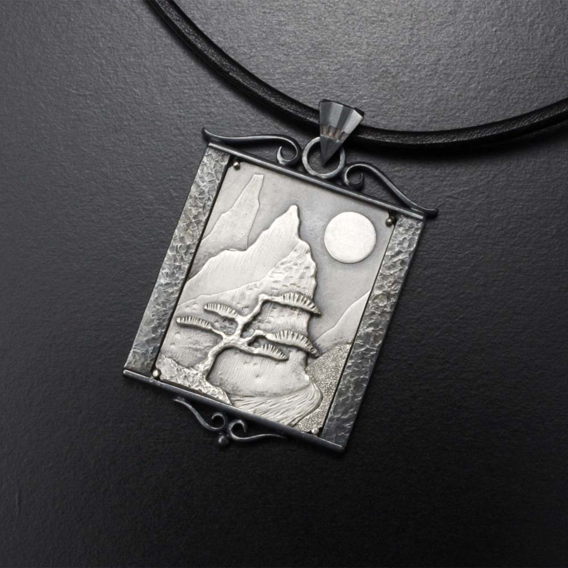 The moon and a pine tree silver pendant