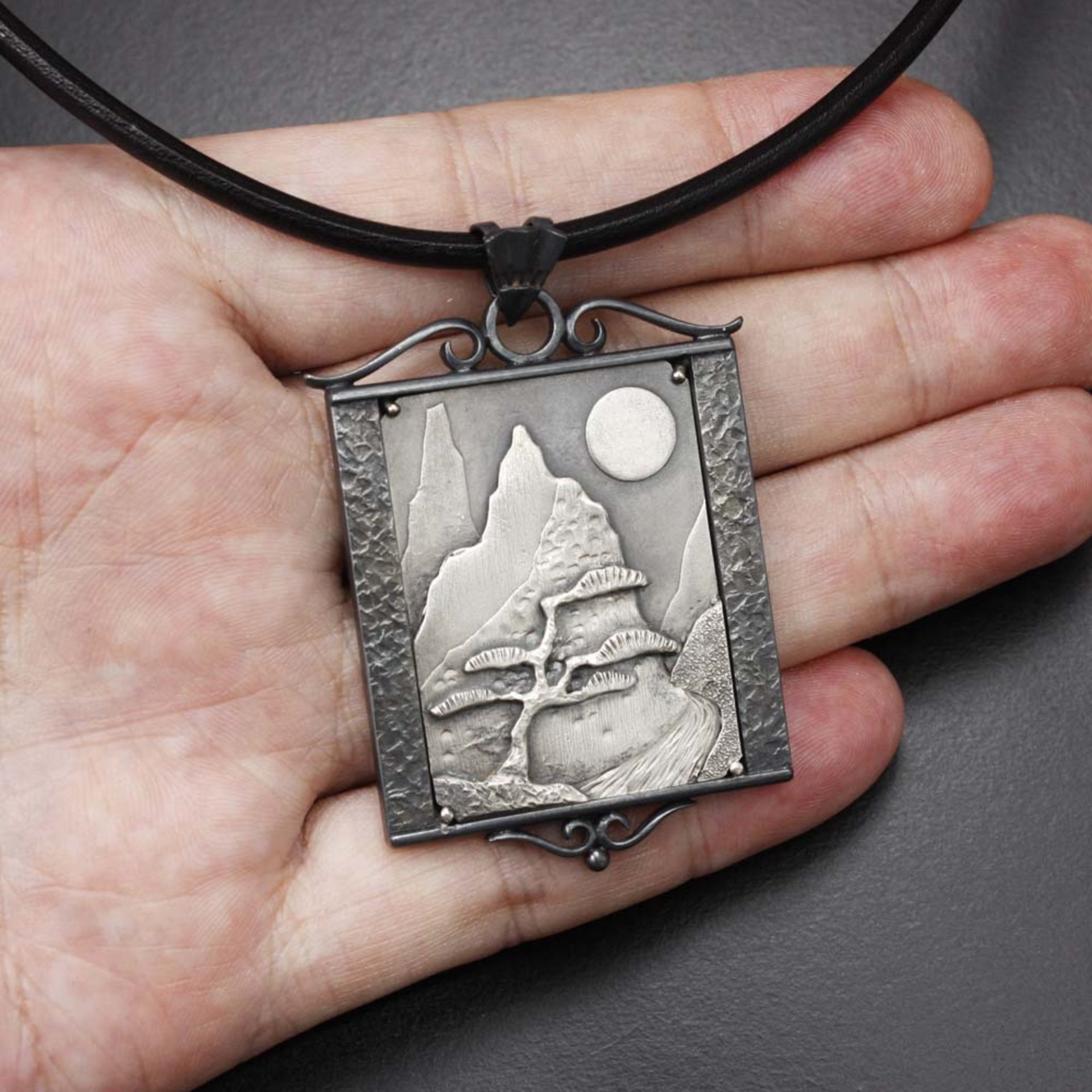 The moon and a pine tree silver pendant