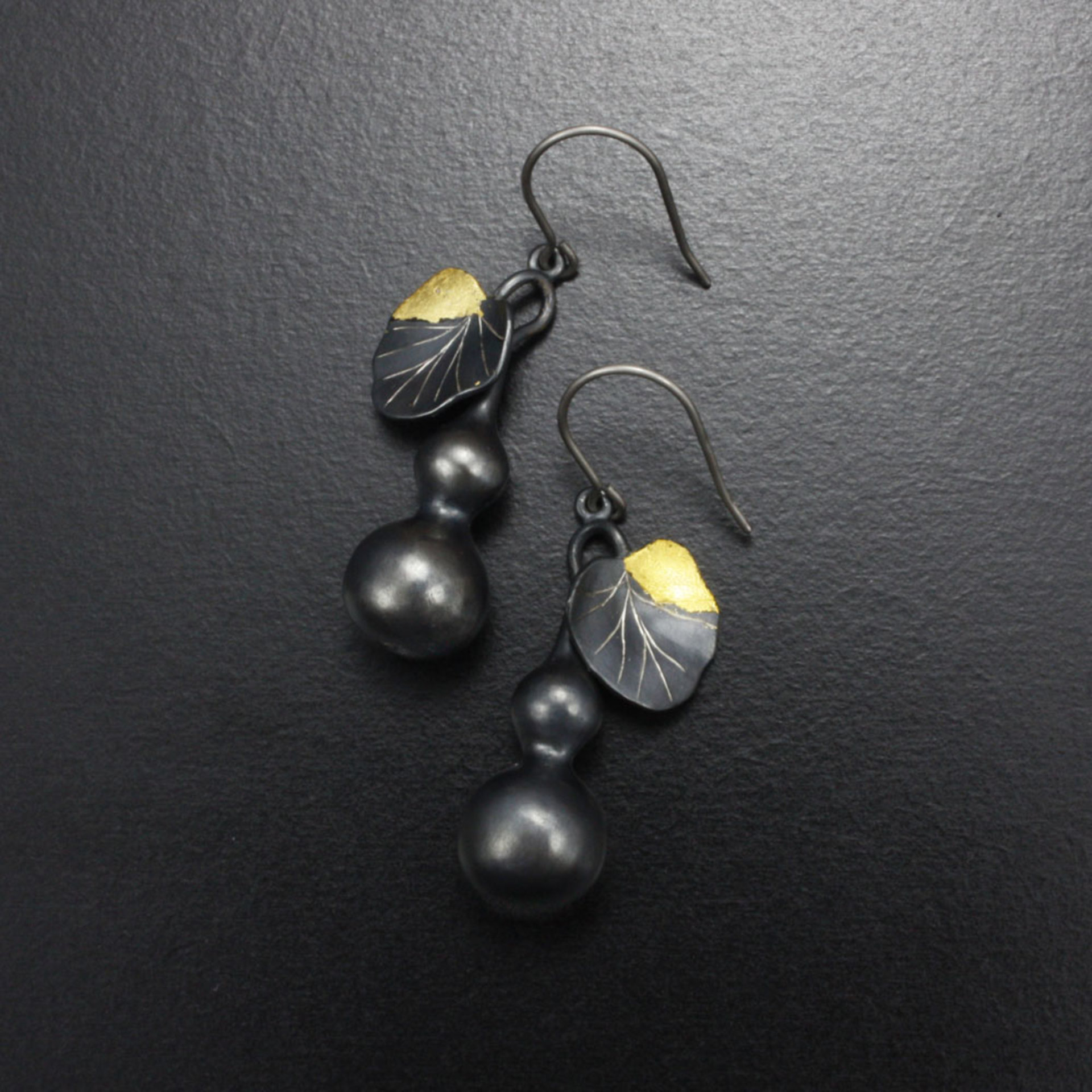 Gourd earrings of patinaed silver with fine gold leaf