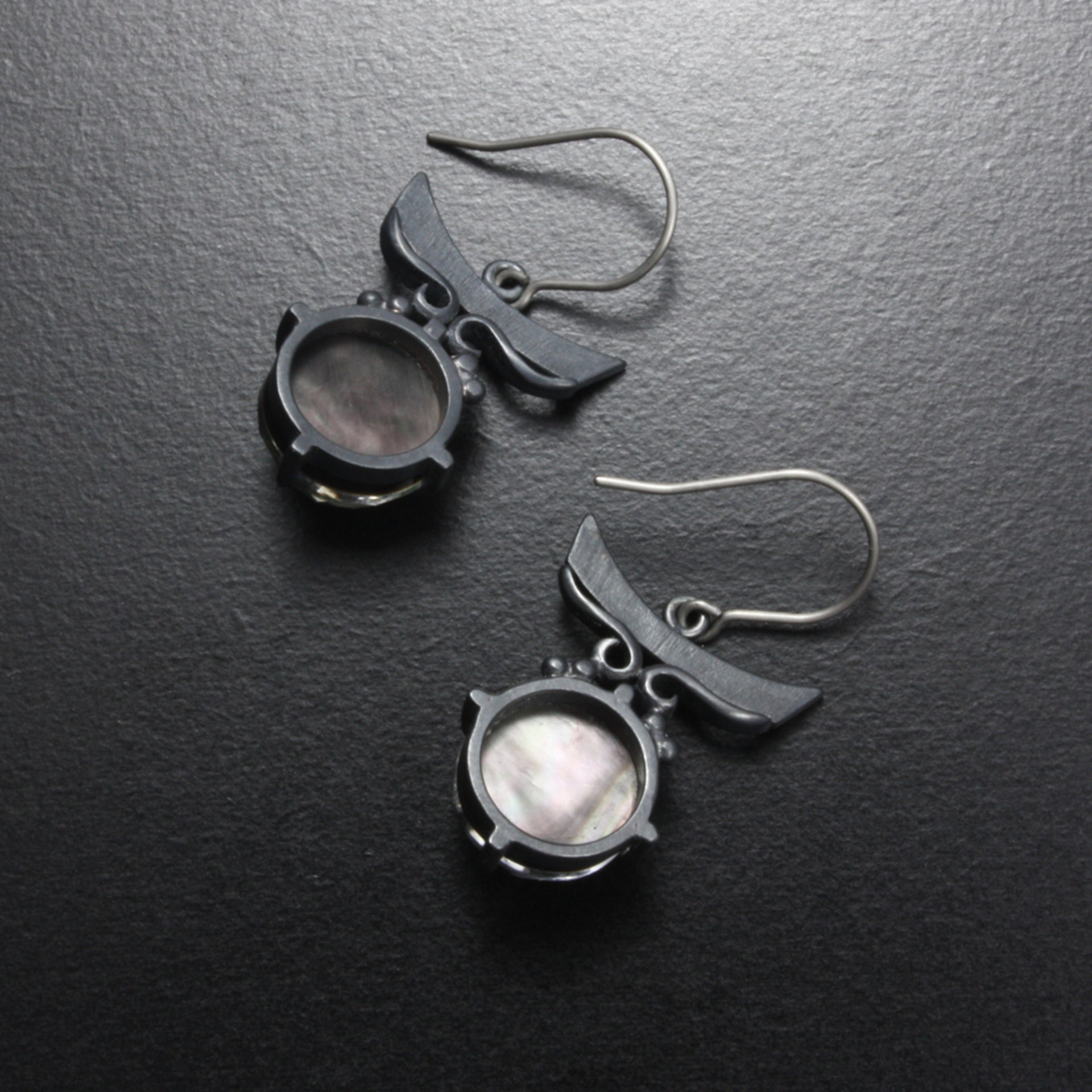 Sold:Silver earrings of quartz backed up by black pearl oyster