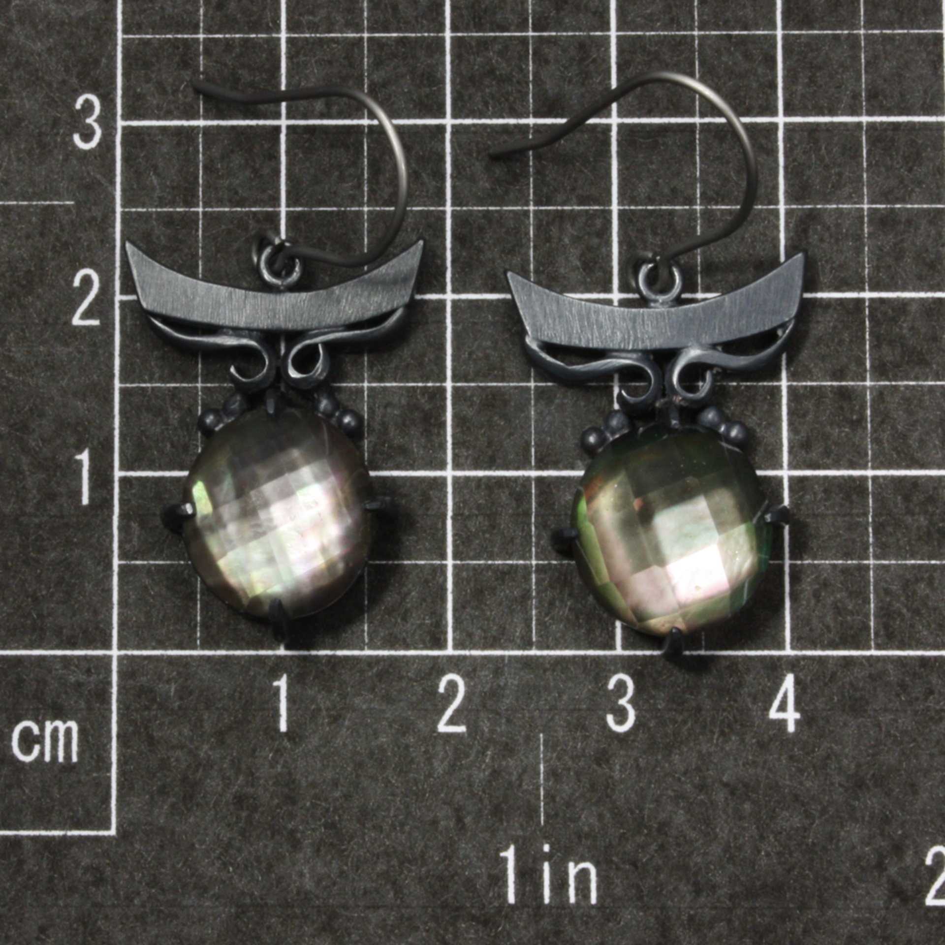 Sold:Silver earrings of quartz backed up by black pearl oyster