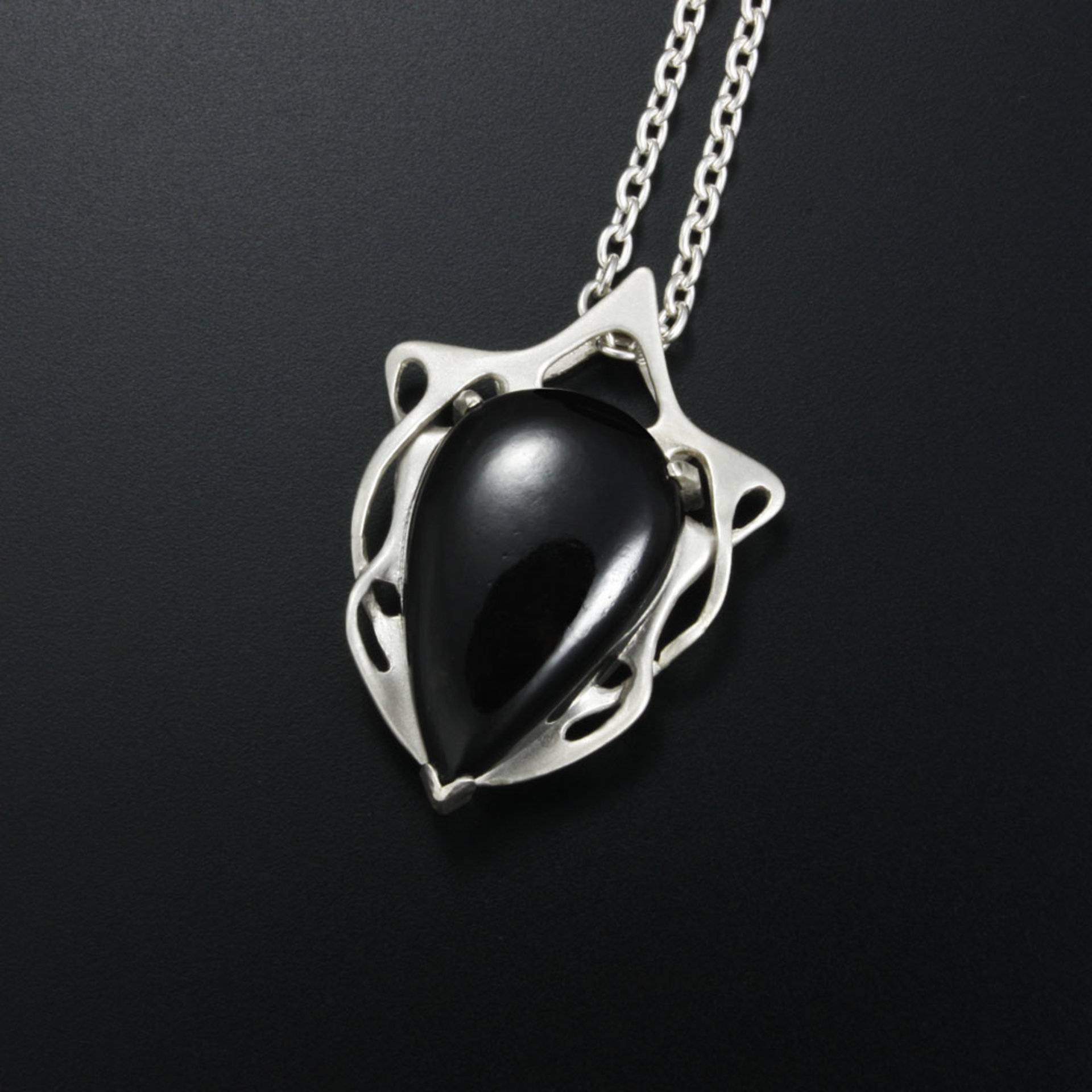 This Art Nouveau style pendant necklace is made of a black tourmaline cab and st