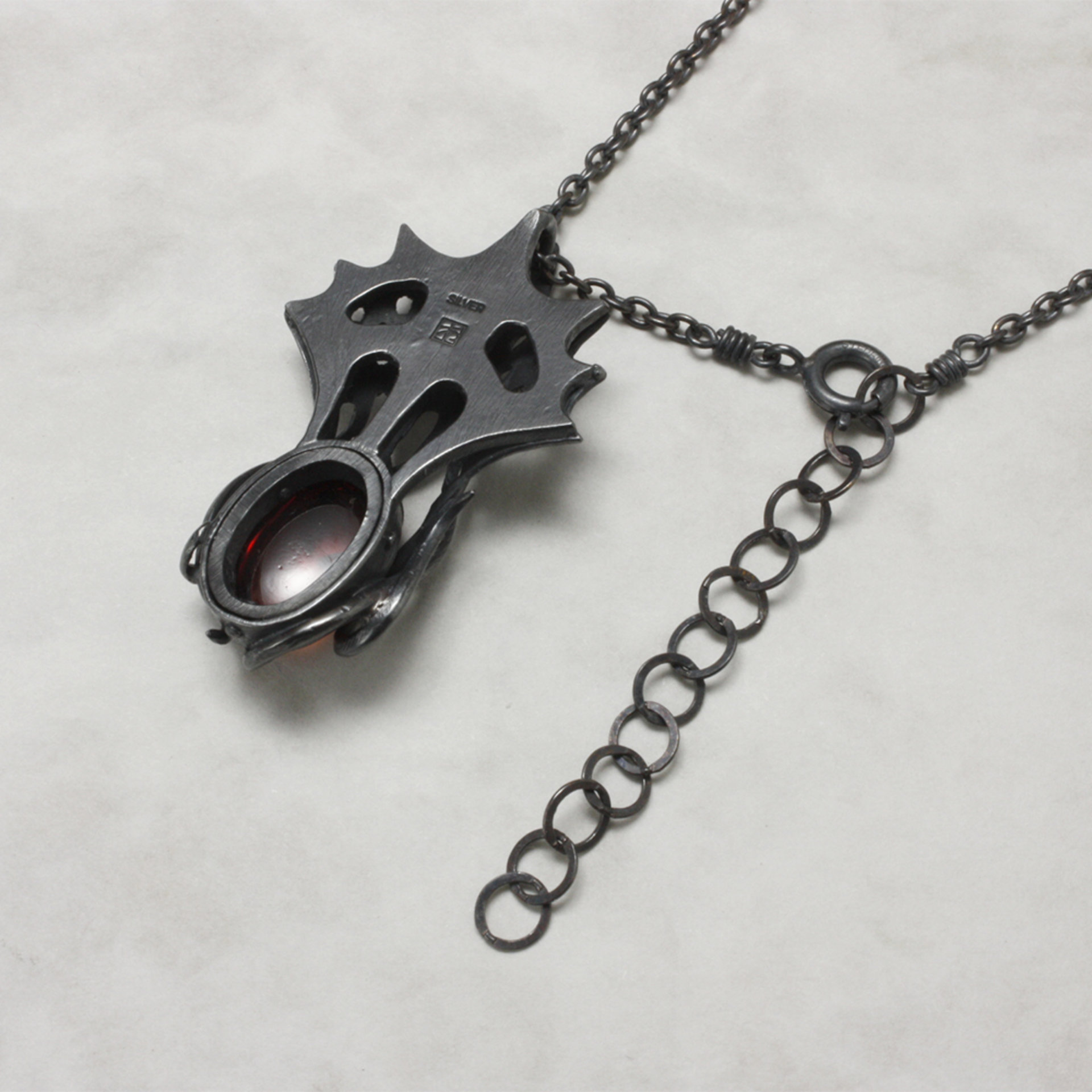 Art Nouveau style tentacles pendant necklace with garnet.