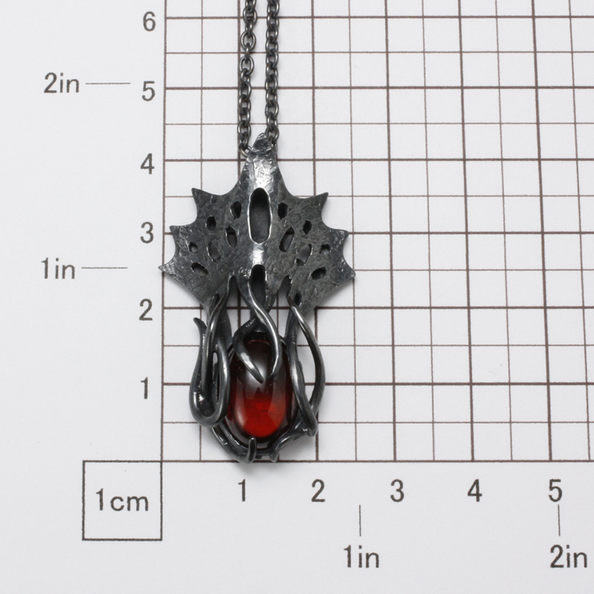 Art Nouveau style tentacles pendant necklace with garnet.