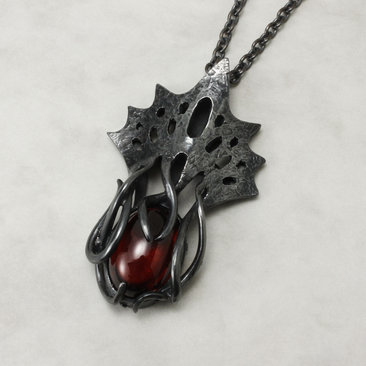 Art Nouveau style tentacles pendant necklace with garnet.